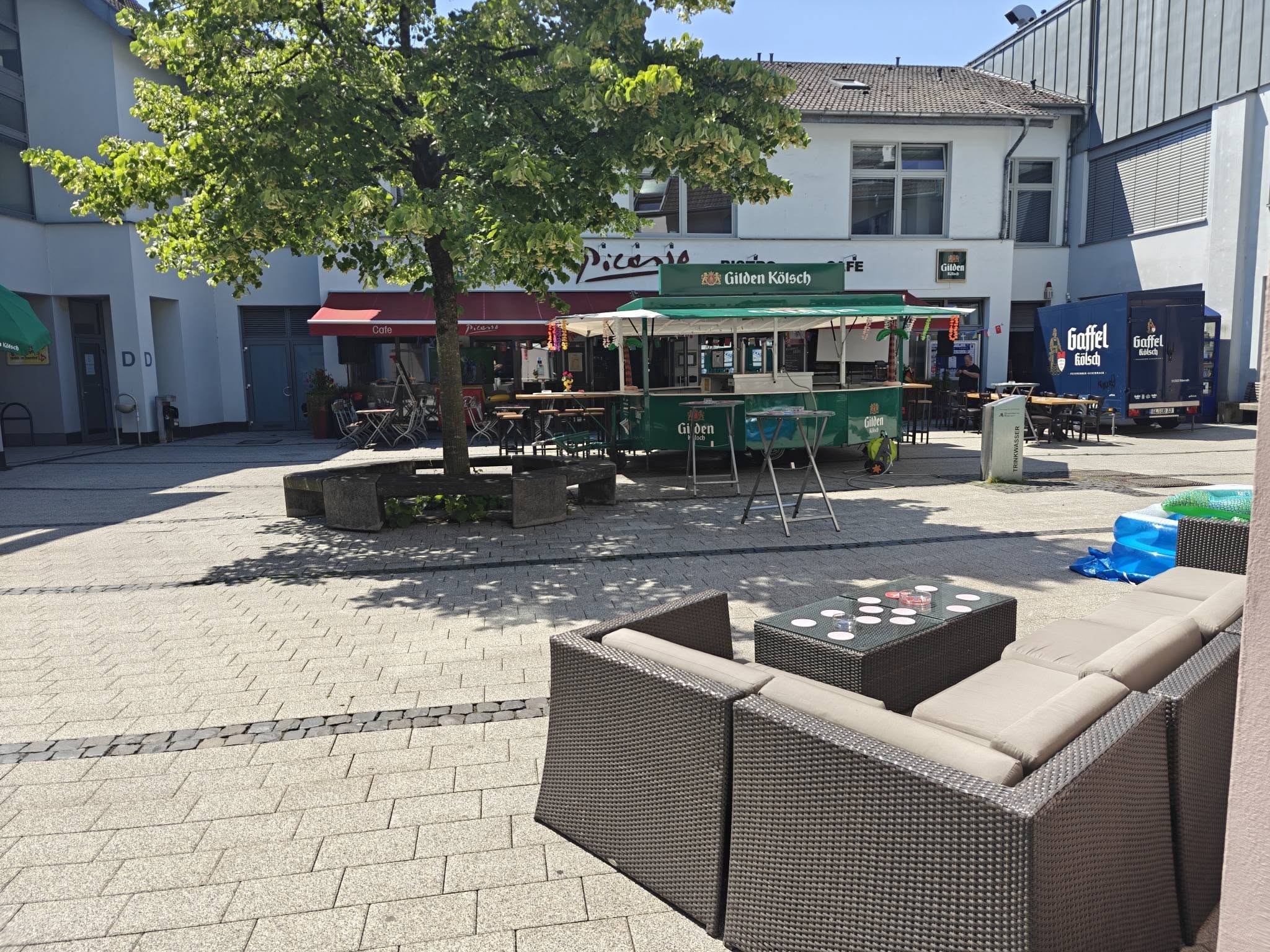 Die sonnige Terrasse des Café Bistro Picasso mit Sitzlounge und Kölschstand.